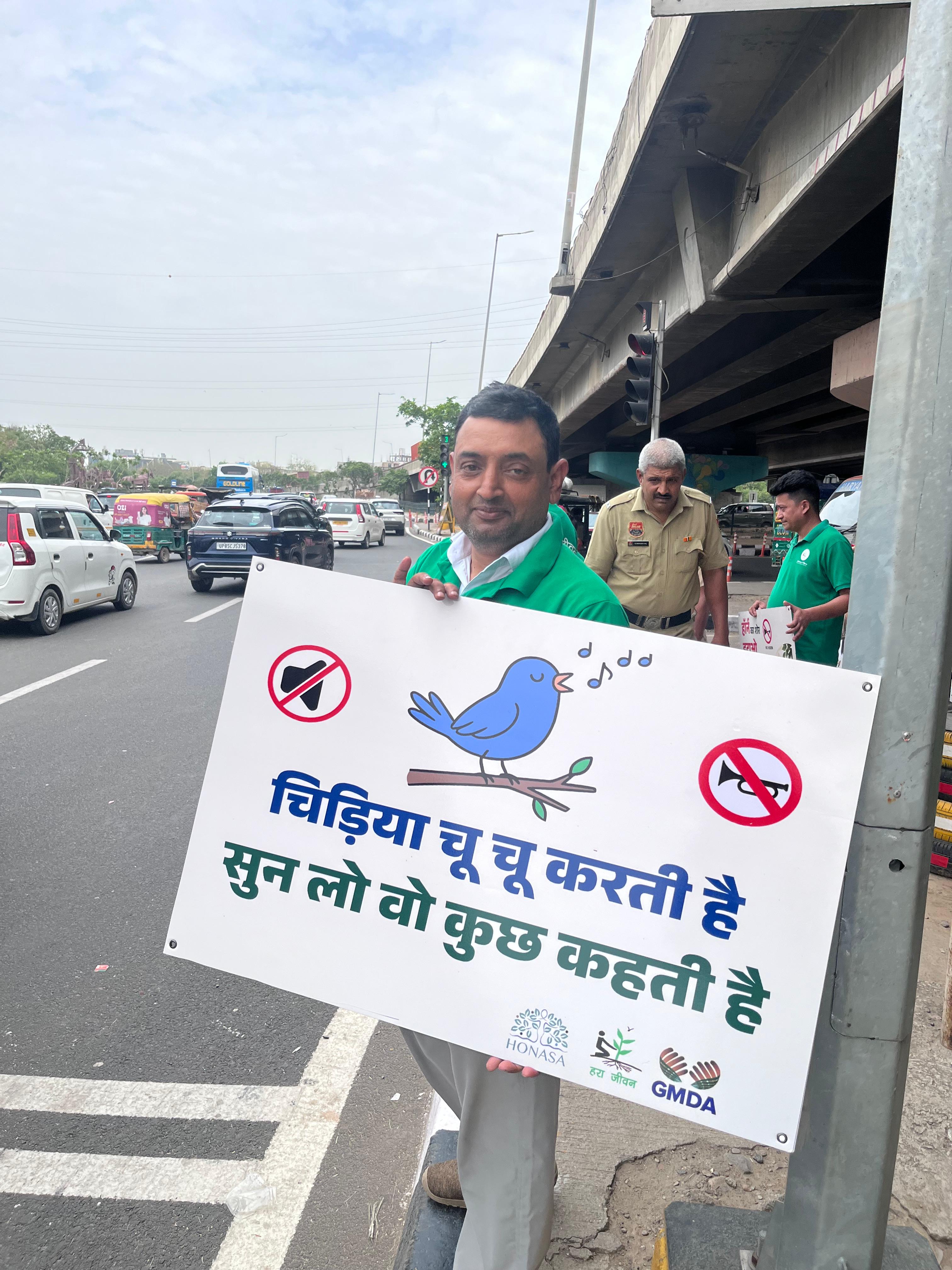 Youth volunteers showing No Honking signs